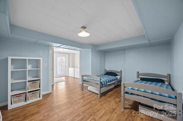a view of a kitchen with furniture and wooden floor