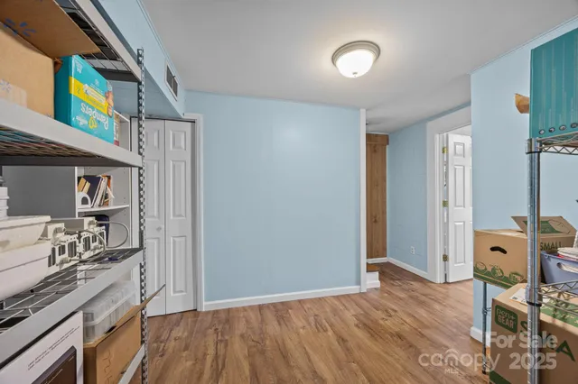 a bedroom with furniture and a book shelf