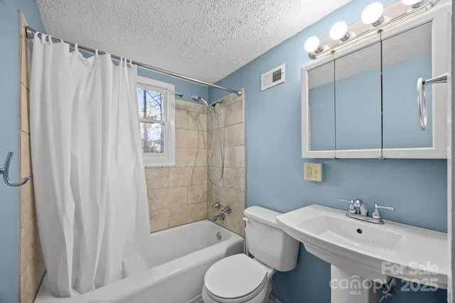 a room with a sink and wooden floor