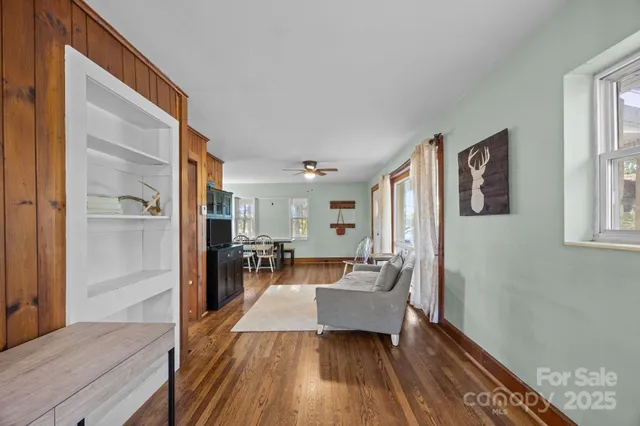 a living room with furniture and a wooden floor