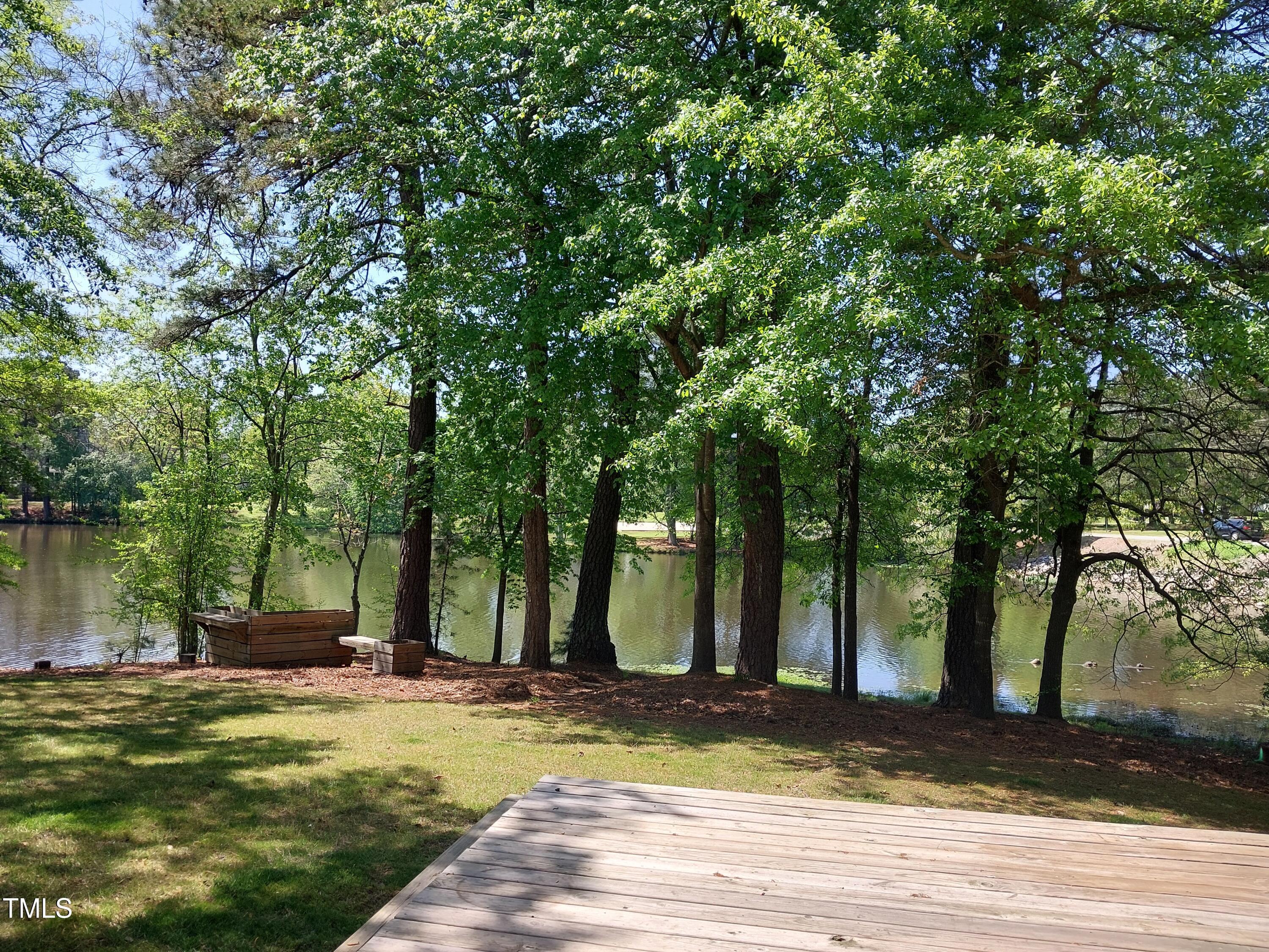 709 Thistlegate Trail Raleigh, NC 27610 - Photo 11 of 40 a view of a house with large trees and a yard