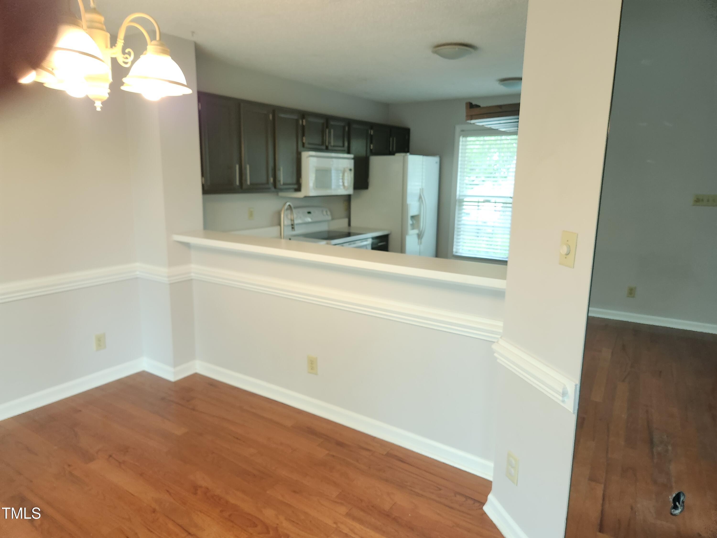 709 Thistlegate Trail Raleigh, NC 27610 - Photo 18 of 40 a view of a kitchen cabinets a sink and dishwasher a stove top oven with wooden floor