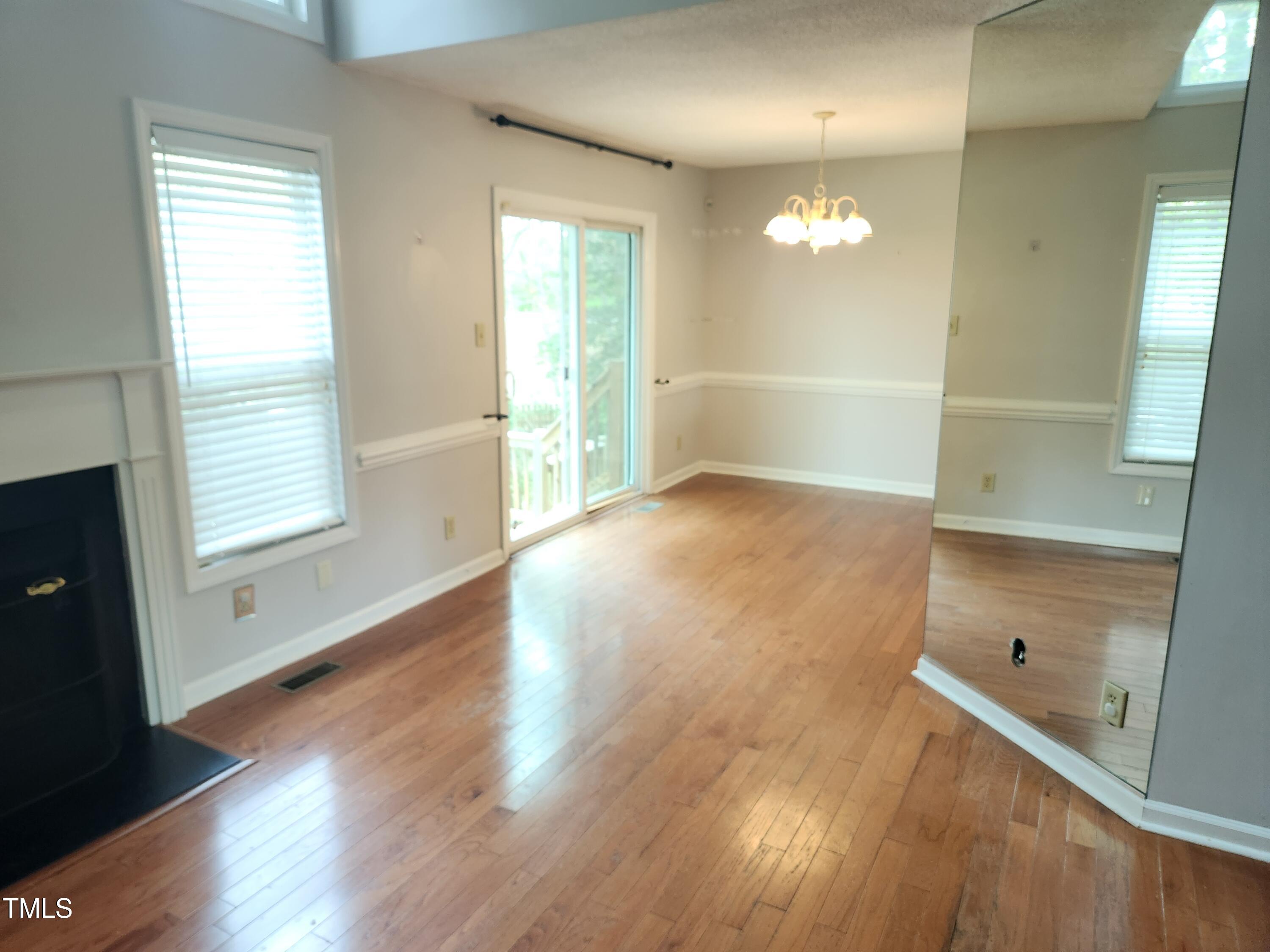 709 Thistlegate Trail Raleigh, NC 27610 - Photo 19 of 40 wooden floor in an empty room with a window