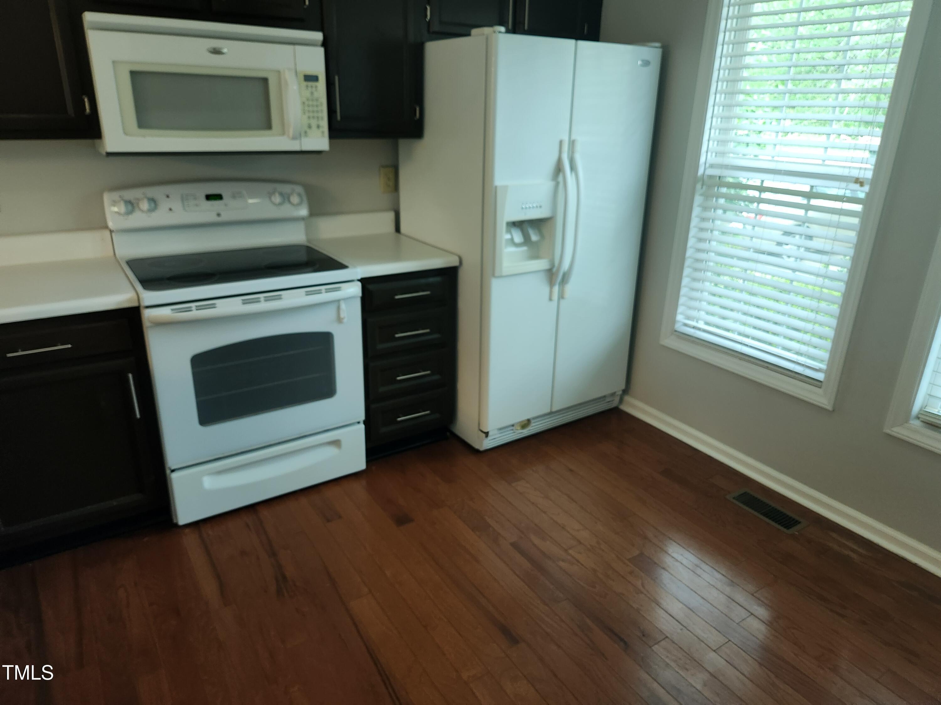 709 Thistlegate Trail Raleigh, NC 27610 - Photo 22 of 40 a kitchen with a stove and a microwave