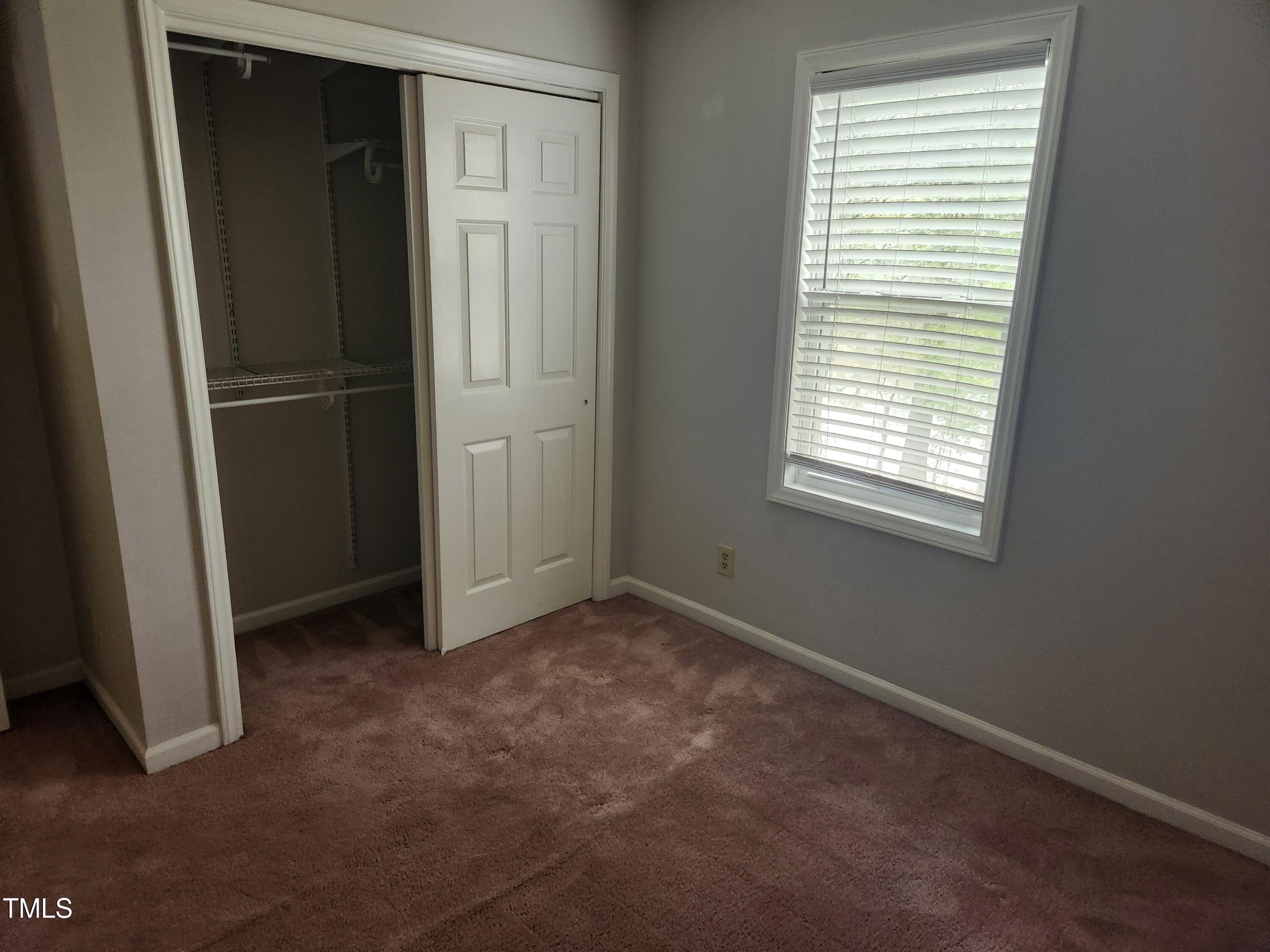 709 Thistlegate Trail Raleigh, NC 27610 - Photo 30 of 40 an empty room with windows and closet