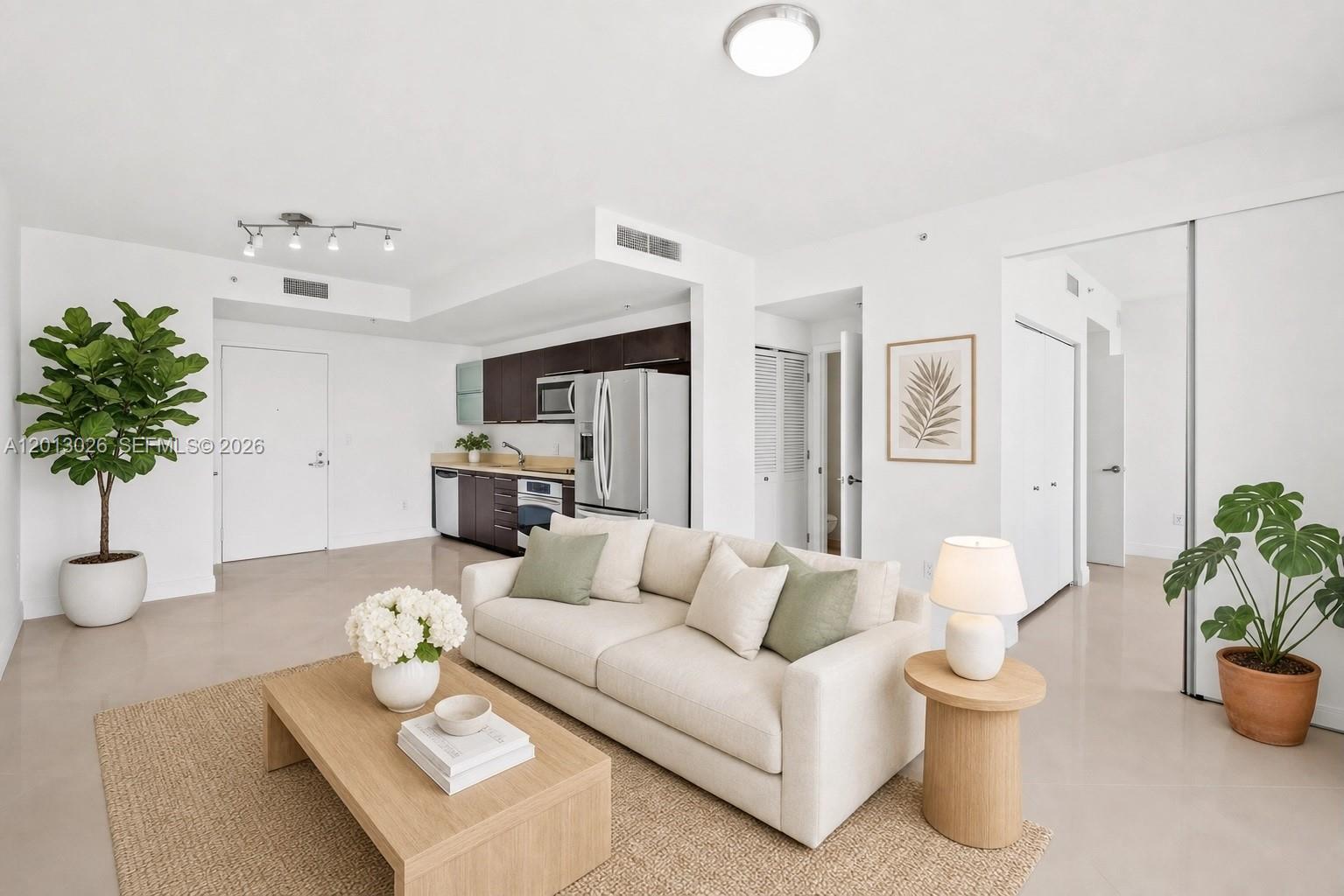 90 Southwest 3rd Street, Unit 1608 Miami, FL 33130 - Photo 2 of 44 a living room with furniture and flowers