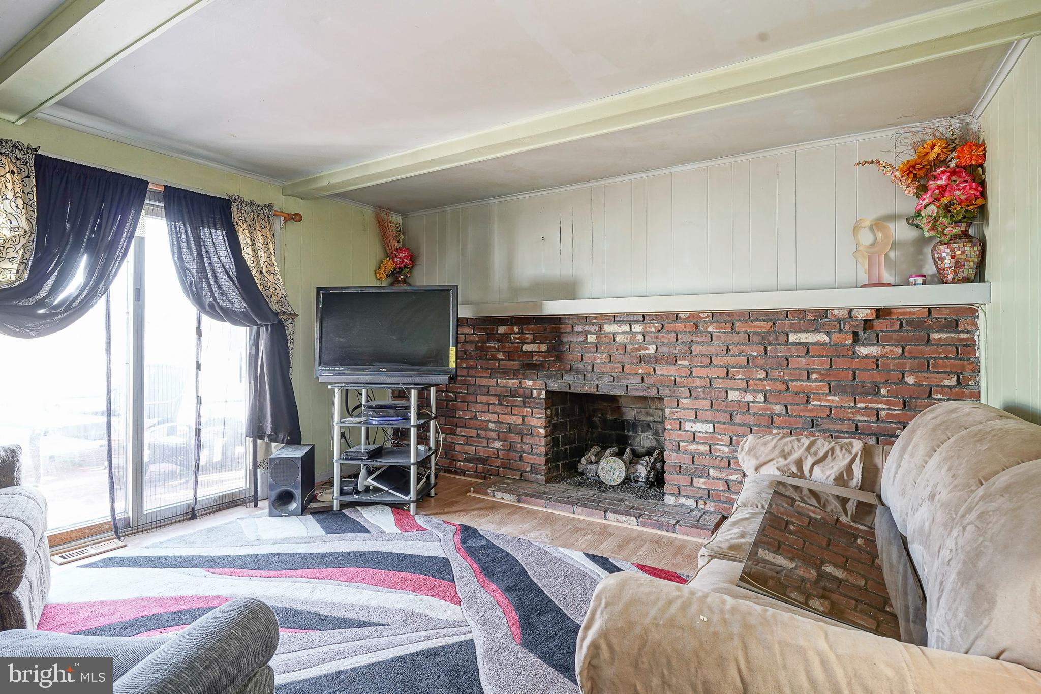 1638 Red Oak Road Williamstown, NJ 08094 - Photo 13 of 23 a living room with furniture a flat screen tv and a fireplace