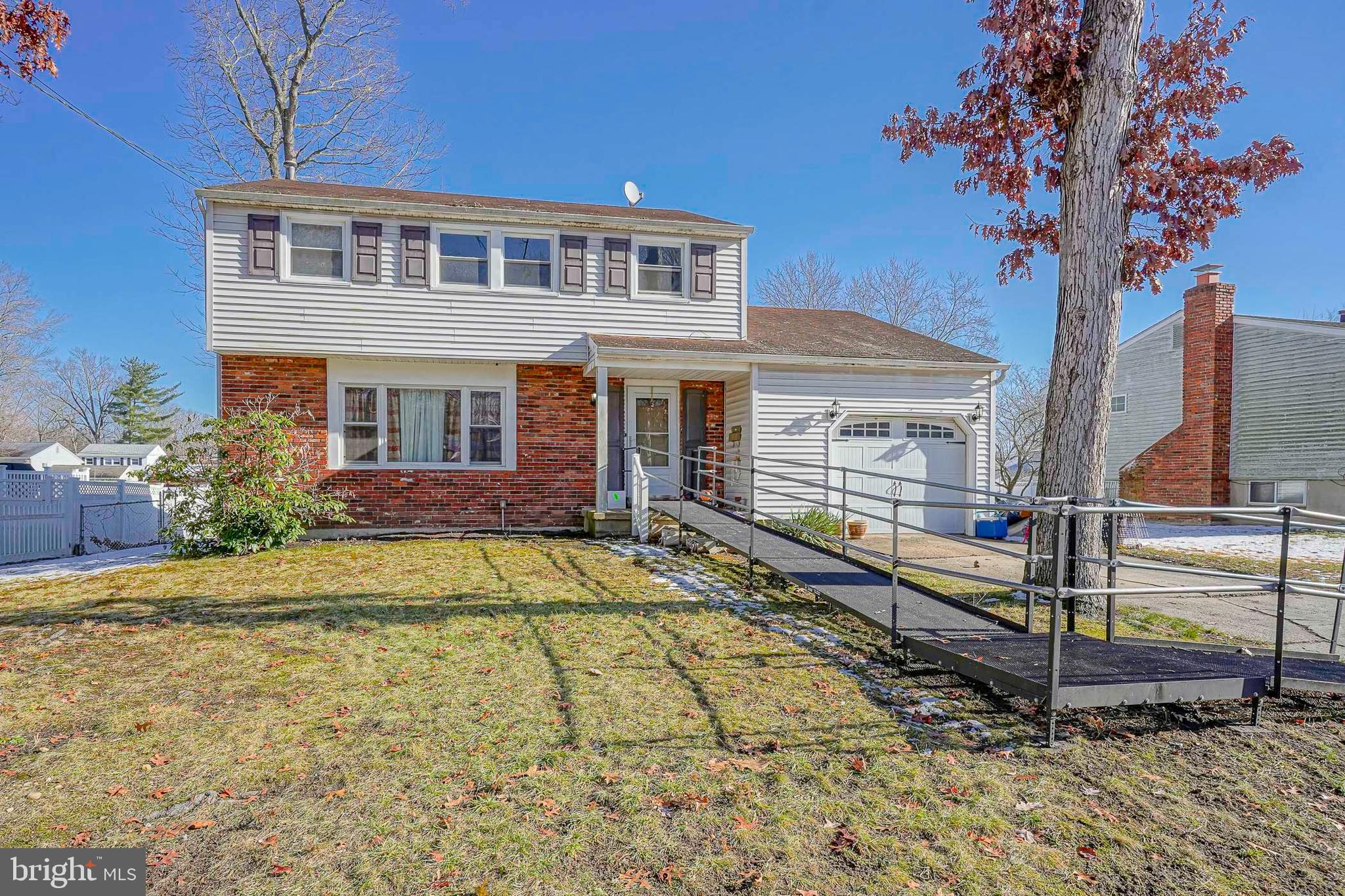 1638 Red Oak Road Williamstown, NJ 08094 - Photo 2 of 23 a front view of a house with a garden