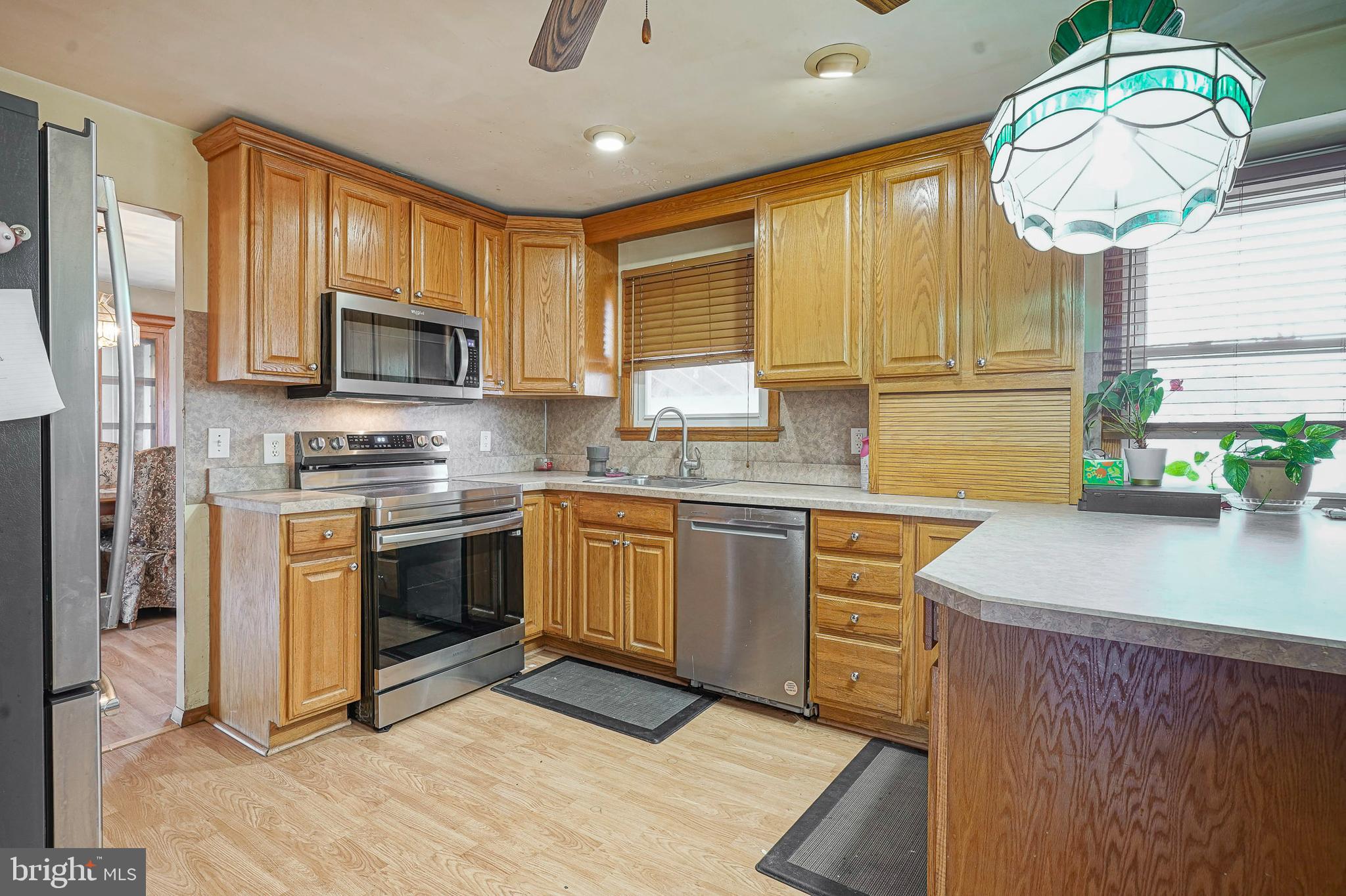 1638 Red Oak Road Williamstown, NJ 08094 - Photo 3 of 23 a kitchen with granite countertop a stove a sink and a microwave
