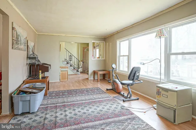 a living room with furniture a wooden floor and a large window
