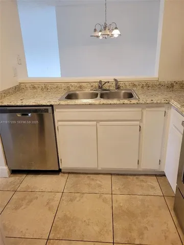 a view of a kitchen with granite countertop cabinets