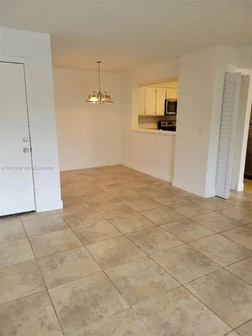 a view of a kitchen with wooden floor and a ceiling fan