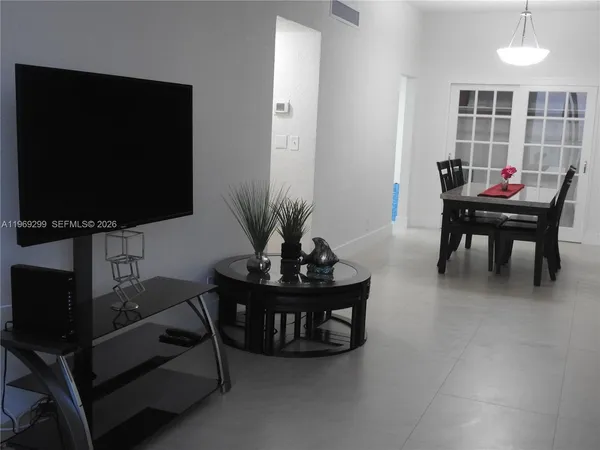 a living room with furniture and a large window
