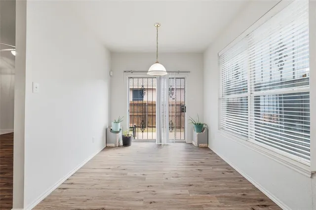 a very nice looking room with wooden floor and a window