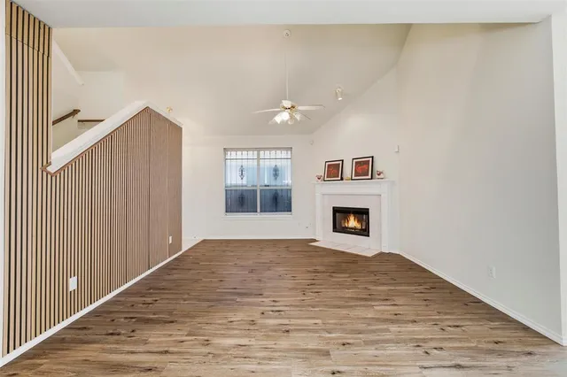 a view of an empty room with a fireplace and a window