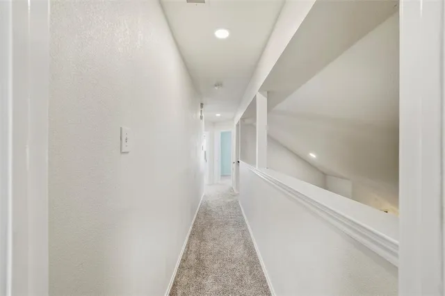a view of a hallway with white walls