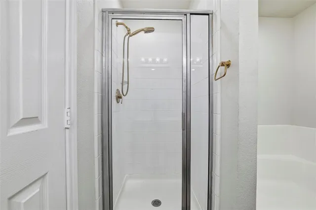 a bathroom with a glass shower door
