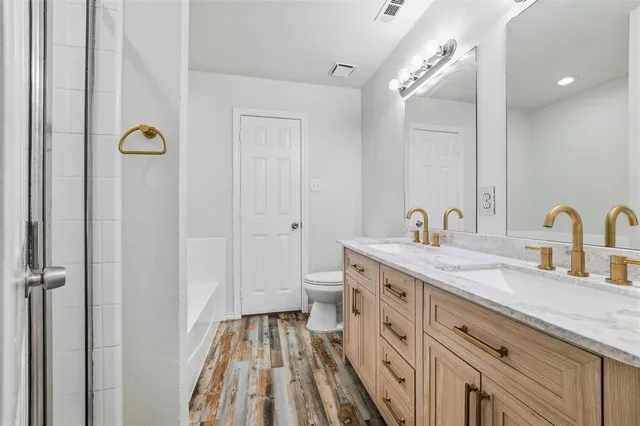 a spacious bathroom with a double vanity sink and a mirror