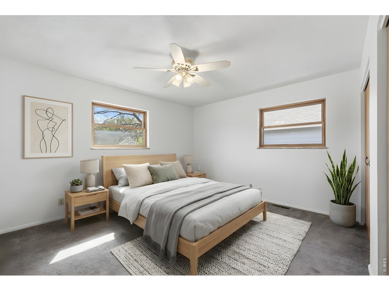 3355 16th Street Boulder, CO 80304 - Photo 11 of 23 a bedroom with a large bed lamp and a chandelier