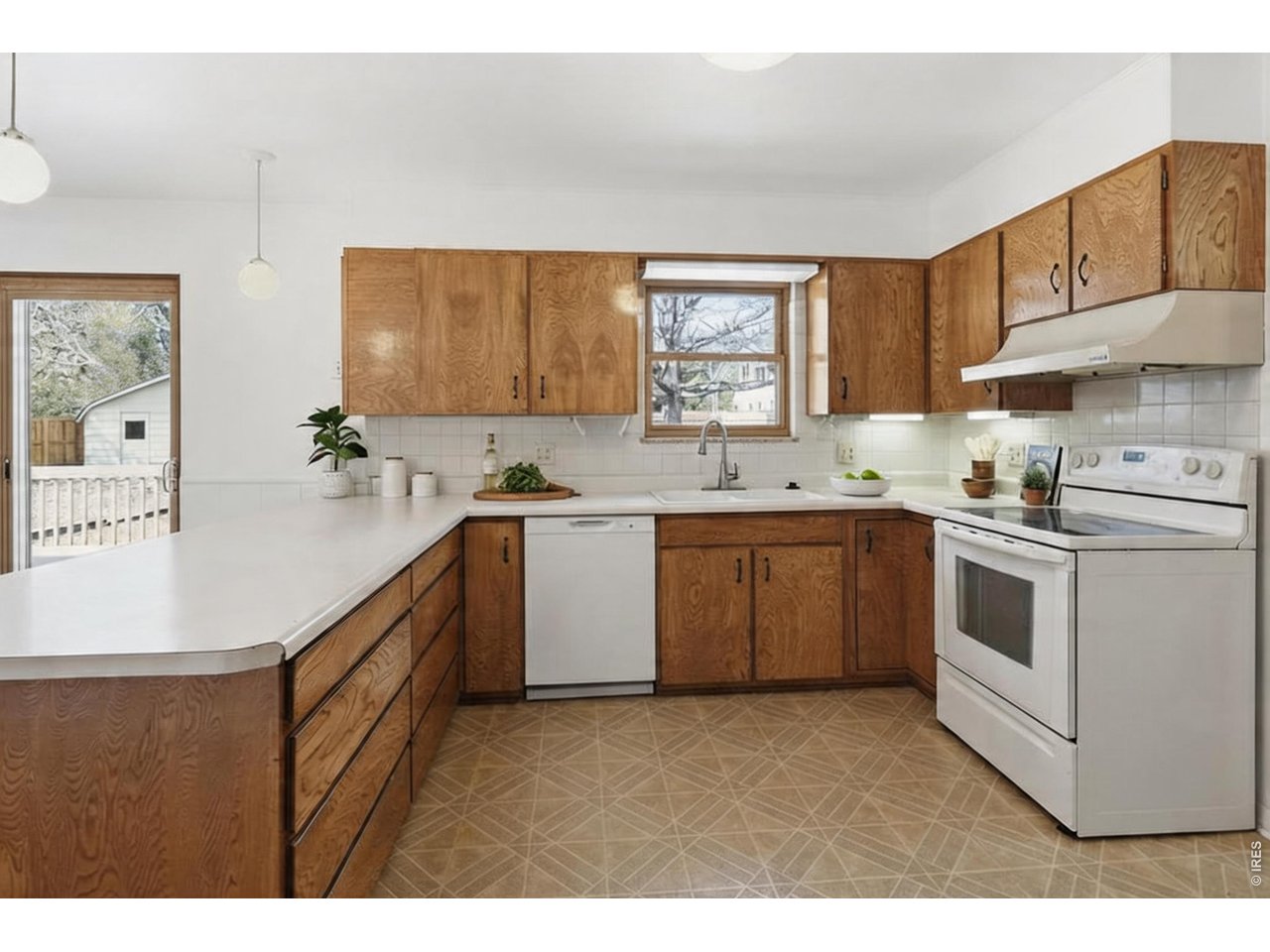3355 16th Street Boulder, CO 80304 - Photo 7 of 23 a kitchen with a sink a stove a microwave a center island and cabinets