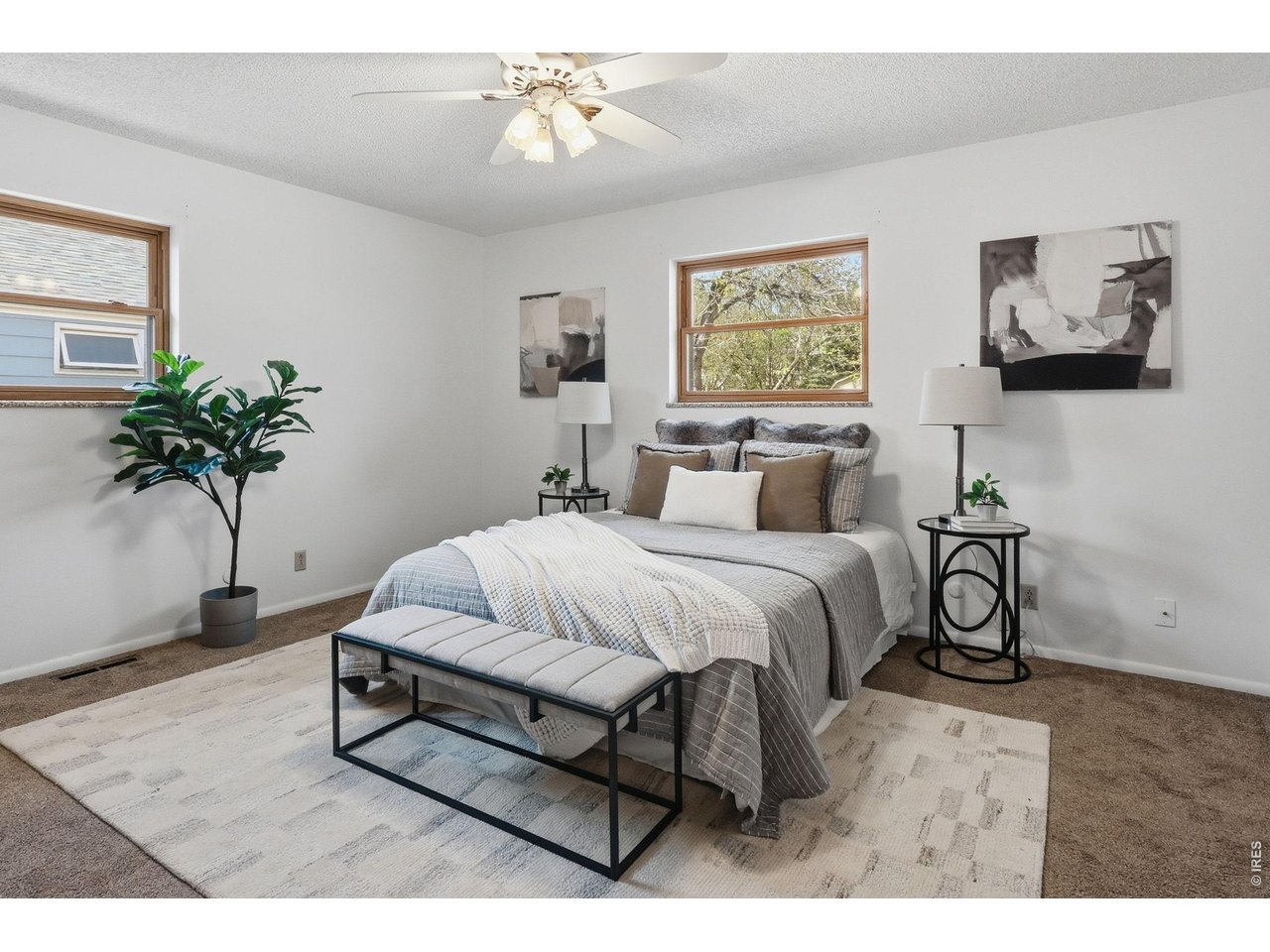 3355 16th Street Boulder, CO 80304 - Photo 9 of 23 a spacious bedroom with a bed and a painting on the wall