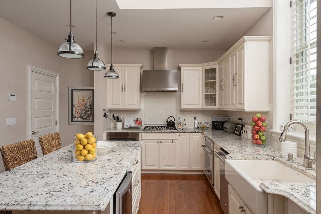 10 Backriver Road, Unit 10 Hingham, MA 02043 - Photo 6 of 30 a kitchen with granite countertop a sink a counter top space appliances and cabinets