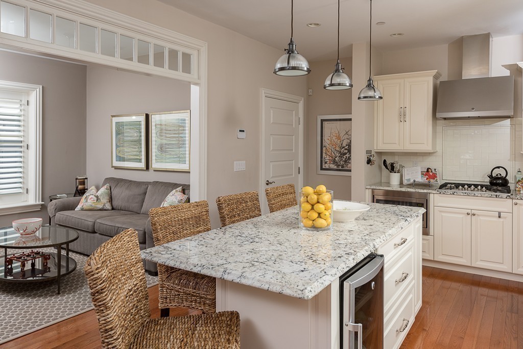 10 Backriver Road, Unit 10 Hingham, MA 02043 - Photo 7 of 30 a kitchen with granite countertop kitchen island stainless steel appliances a sink stove and refrigerator