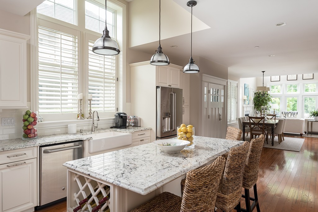 10 Backriver Road, Unit 10 Hingham, MA 02043 - Photo 8 of 30 a kitchen with a table chairs sink and cabinets