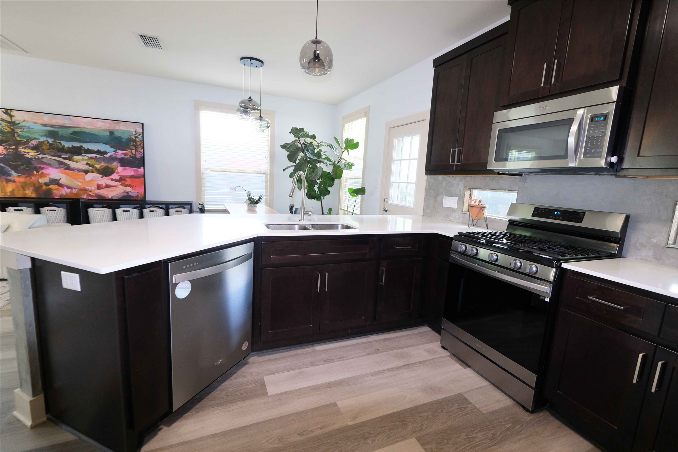 604 Allen Street, Unit 104 Austin, TX 78702 - Photo 2 of 16 a kitchen with a sink stove and microwave