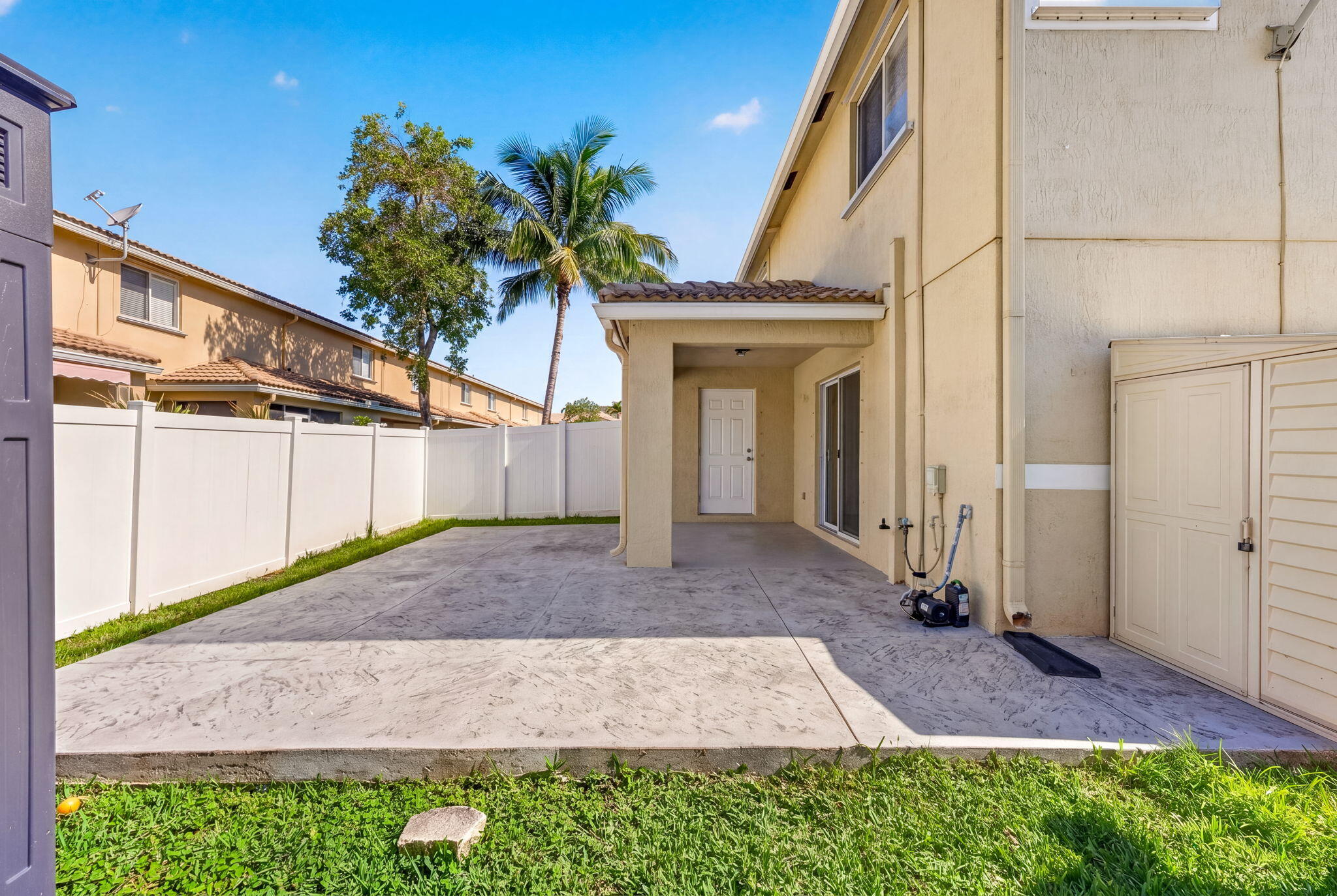 5951 Manchester Way Tamarac, FL 33321 - Photo 14 of 41 a front view of a house with a yard and garage
