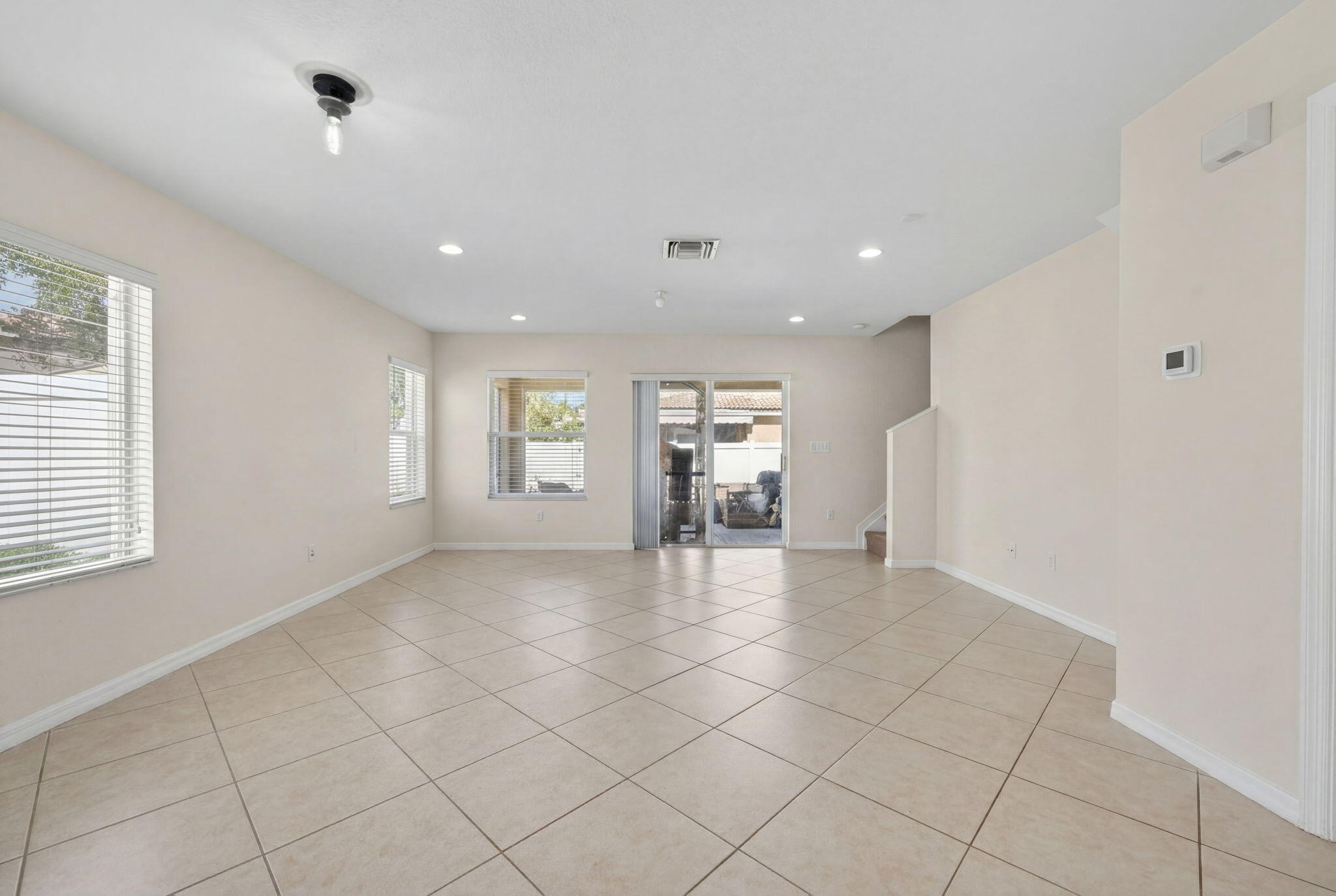 5951 Manchester Way Tamarac, FL 33321 - Photo 29 of 41 a view of an empty room with window and chandelier