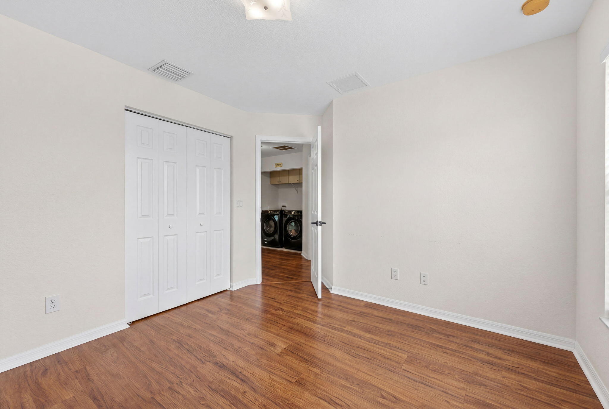 5951 Manchester Way Tamarac, FL 33321 - Photo 31 of 41 a view of an empty room with wooden floor