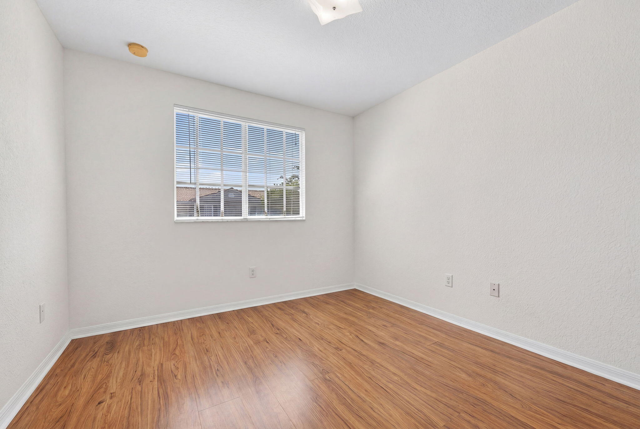 5951 Manchester Way Tamarac, FL 33321 - Photo 32 of 41 wooden floor in an empty room with a window