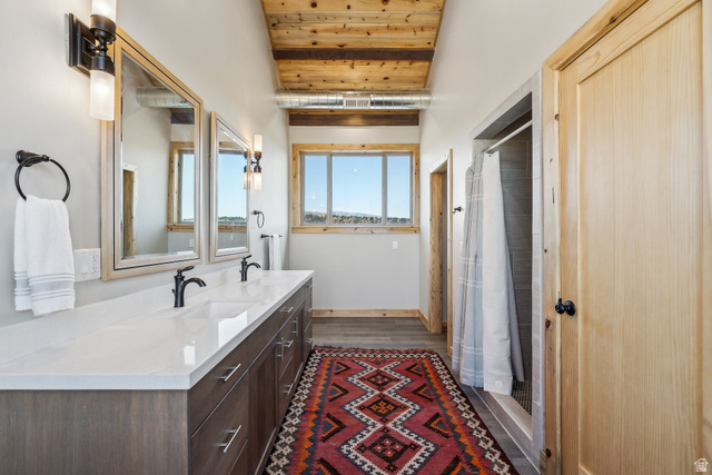 46997 West Thunder Road Fruitland, UT 84027 - Photo 28 of 49 Bathroom with a stall shower, wood ceiling, double vanity, and dark wood finished floors