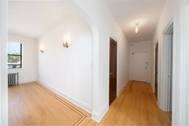 a view of a hallway with wooden floor