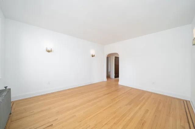 a view of a room with wooden floor and white walls