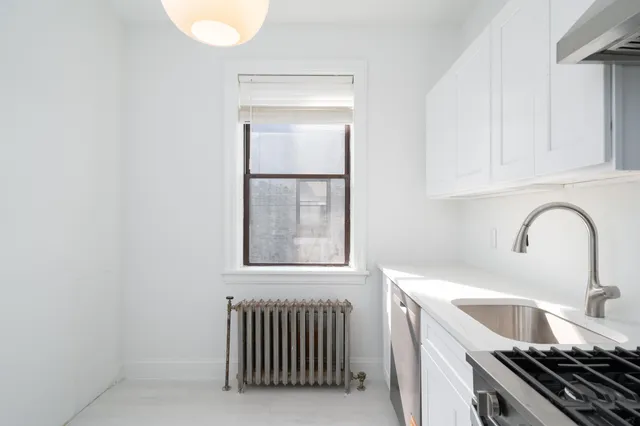 a kitchen with a sink and a stove top oven