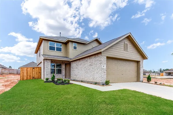 a front view of house with yard and tress