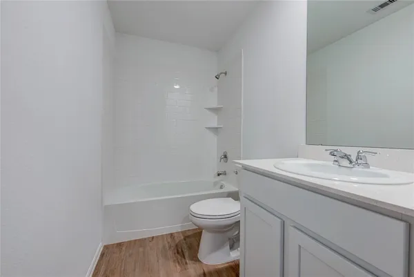 a bathroom with a sink toilet vanity and tub