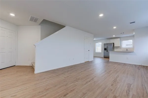 a view of a kitchen with wooden floor and a kitchen