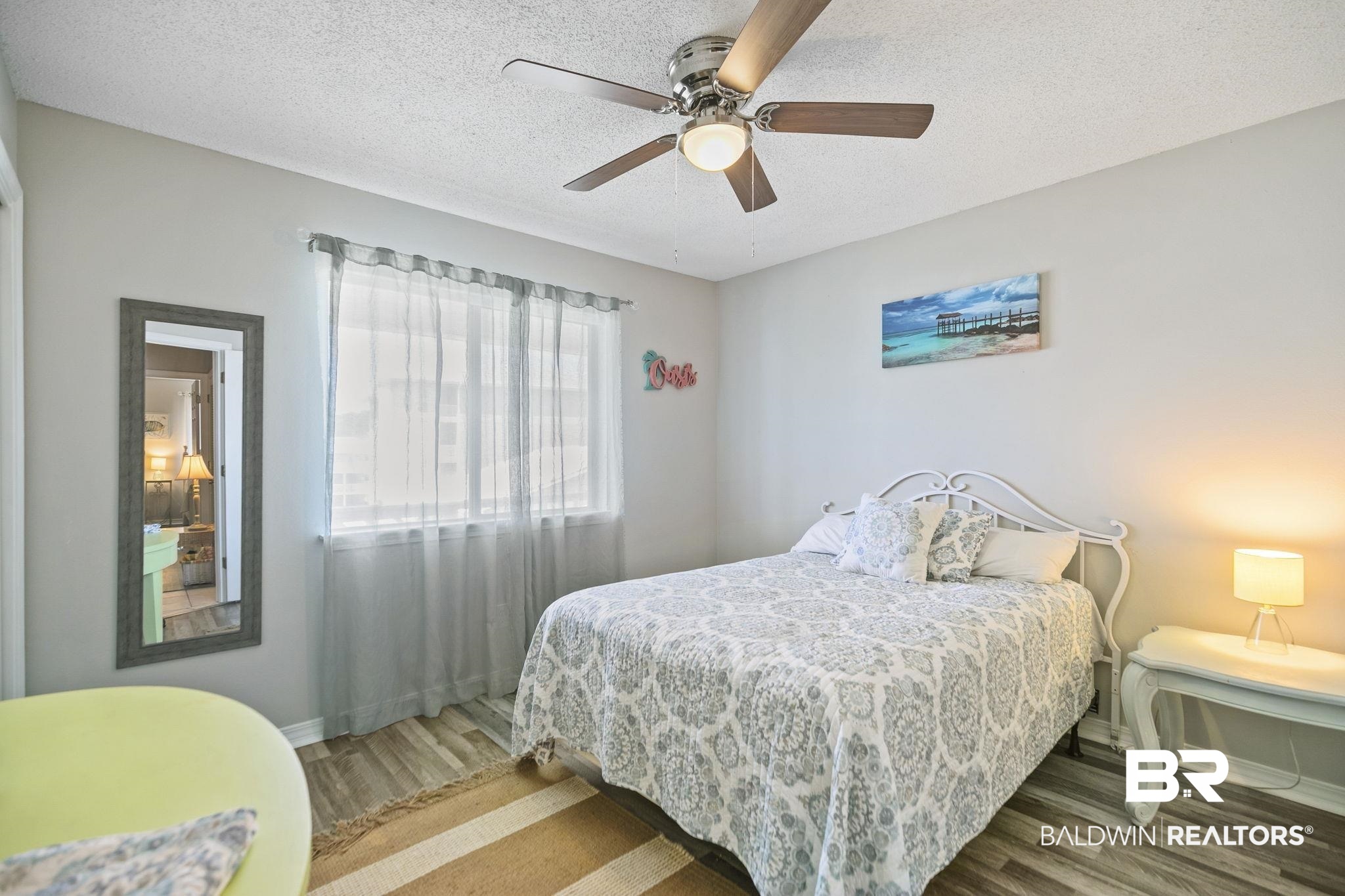 25957 Canal Road, Unit 302 Orange Beach, AL 36561 - Photo 15 of 26 Bedroom with ceiling fan, hardwood / wood-style flooring, and a textured ceiling