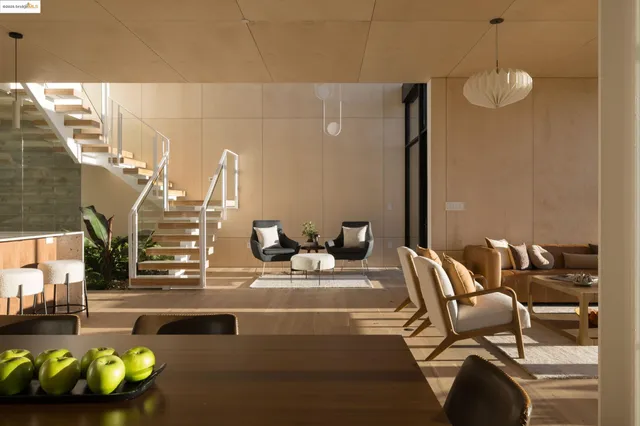 a dining room with furniture water view and a floor to ceiling window