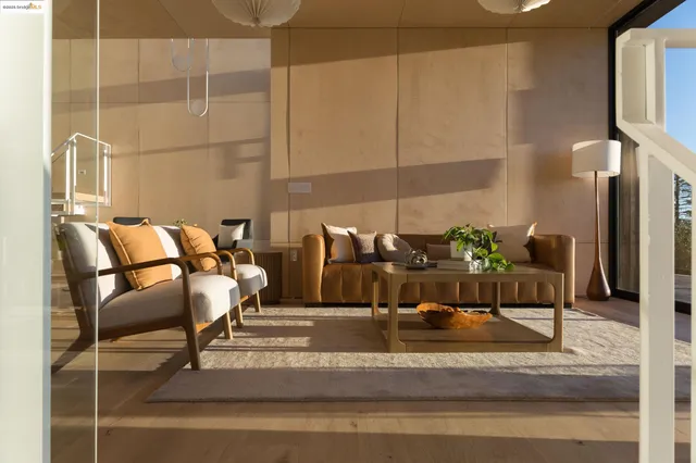 a work room with furniture and a floor to ceiling window