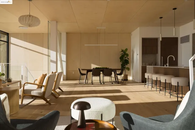 a kitchen with stainless steel appliances granite countertop a sink a stove a dining table and chairs with wooden floor