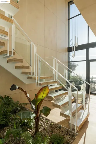 an aerial view of a house with a yard and large trees