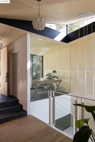 a view of a hallway with windows and stairs