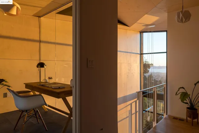 a view of a workspace with furniture and window