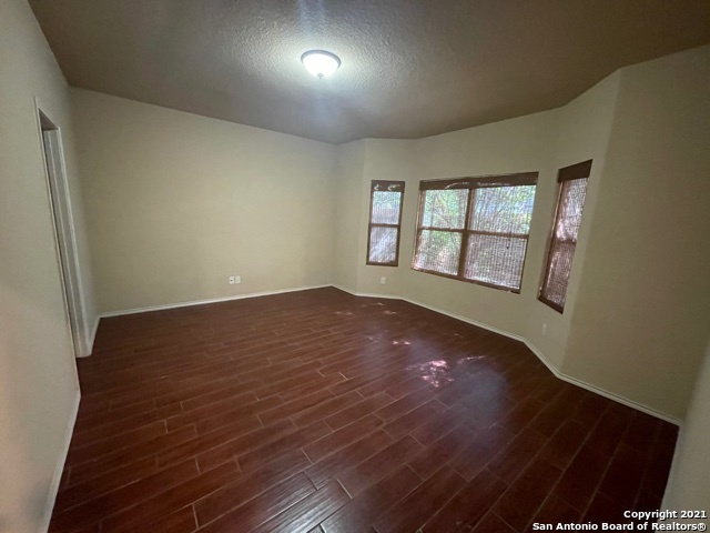 434 Tequila Ranch San Antonio, TX 78245 - Photo 15 of 21 an empty room with wooden floor and windows