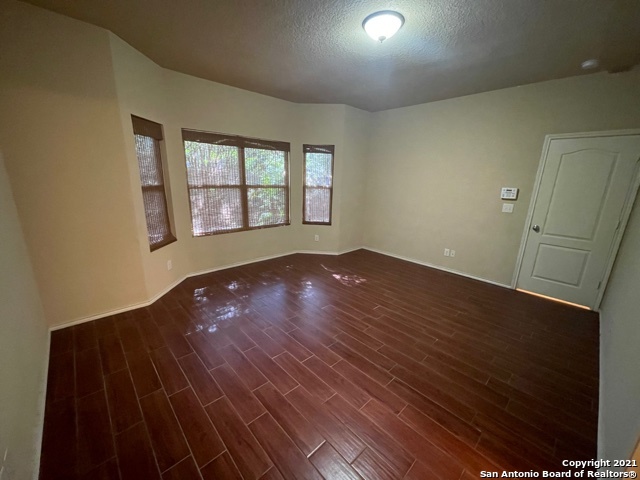 434 Tequila Ranch San Antonio, TX 78245 - Photo 16 of 21 an empty room with wooden floor and windows
