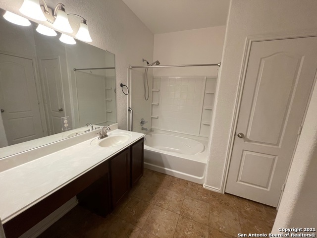 434 Tequila Ranch San Antonio, TX 78245 - Photo 17 of 21 a bathroom with a double vanity sink a toilet and a shower